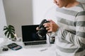 Male photographer holding digital camera above the desk in his photo studio Royalty Free Stock Photo