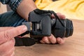 Photographer placing an sd memory card in a professional still camera Royalty Free Stock Photo