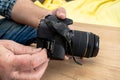 Photographer placing an sd memory card in a professional still camera Royalty Free Stock Photo