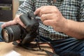 Photographer placing an sd memory card in a professional still camera Royalty Free Stock Photo