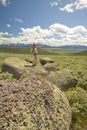 Male photographer by large rocks and mountains in Centennial Valley near Lakeview, MT