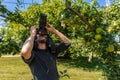 Male photographer man in apple orchard Royalty Free Stock Photo