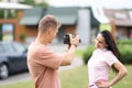 Male photographer photographs female model on street. Royalty Free Stock Photo