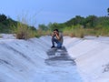 Male photographer shooting camera at dried waterway