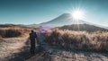 Male photographer taking photos in a beautiful nature setting. Silhouette Photographer With Fuji Mount Royalty Free Stock Photo