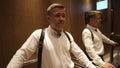 A male photographer unload goes up in the elevator to the bride's room.