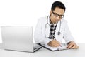 Male physician with clipboard on studio Royalty Free Stock Photo