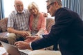 Male physician discussing over the laptop with senior couple at retirement home Royalty Free Stock Photo