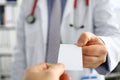 Male physician hand holding and giving white blank calling card Royalty Free Stock Photo