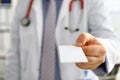 Male physician hand holding and giving white blank calling card Royalty Free Stock Photo