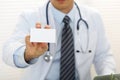 Male physician hand holding and giving white blank calling card Royalty Free Stock Photo