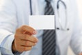 Male physician hand holding and giving white blank calling card Royalty Free Stock Photo