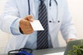 Male physician hand holding and giving white blank calling card Royalty Free Stock Photo