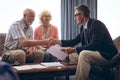 Male physician interacting with senior couple at retirement home
