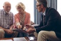 Male physician interacting with senior couple at retirement home Royalty Free Stock Photo