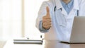 Male physician showing thumb up gesture advising best hospital service Royalty Free Stock Photo