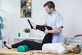 Male physiotherapist exercising with patient