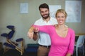 Male physiotherapist giving arm massage to female patient Royalty Free Stock Photo