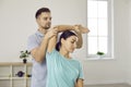 Male physiotherapist help patient with arm recovery