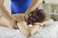 Male physiotherapist massage female client in saloon