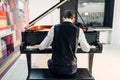Male pianist playing composition on grand piano