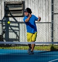 Male pickleball player hits the ball from the baseline Royalty Free Stock Photo