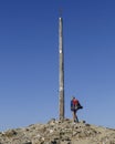 Male pilgrim at the Cruz de Hierro Iron Cross on the Camino de Santiago, Spain.