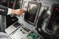 Male pilot turn button on passenger airplane jet