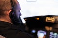 Male pilot using airplane cockpit command to fly jet Royalty Free Stock Photo