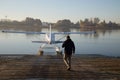 Male pilot walking toward seaplane water