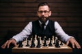 Male player against chess board with pieces set