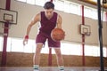 Male player practicing basketball