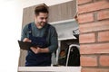 Male plumber with clipboard near kitchen sink Royalty Free Stock Photo