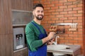 Male plumber with clipboard near kitchen sink Royalty Free Stock Photo