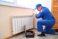 Male plumber fixes a leak. The adjustable wrench tighten the nut clamps seals, isolates