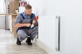 Male Plumber Fixing Thermostat Using Wrench Royalty Free Stock Photo