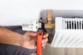 Male Plumber Fixing Thermostat Using Wrench Royalty Free Stock Photo