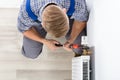 Male Plumber Fixing Thermostat Using Wrench Royalty Free Stock Photo