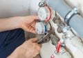 Male plumber fixing water meter. Royalty Free Stock Photo