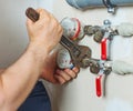 Male plumber fixing water meter. Royalty Free Stock Photo