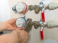 Male plumber fixing water meter. Royalty Free Stock Photo