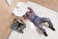 Male Plumber Lying On Floor Repairing Sink In Bathroom Royalty Free Stock Photo