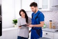 Male Plumber Showing Invoice To Woman Royalty Free Stock Photo