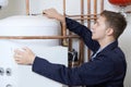Male Plumber Working On Central Heating Boiler Royalty Free Stock Photo