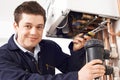 Male Plumber Working On Central Heating Boiler Royalty Free Stock Photo