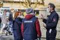 Male police officer instructs young women from German law enforcement agency on their work at Corona demonstration