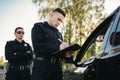 Male police officers check vehicle on the road Royalty Free Stock Photo