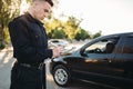 Male police officers writes a fine on the road Royalty Free Stock Photo