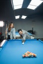 male pool player with glove poking the white ball Royalty Free Stock Photo