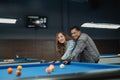 male pool player teaching the female cue player to choose the object ball Royalty Free Stock Photo